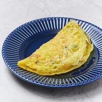 Crispy Vietnamese Crepe omelet served in a dish isolated on grey background side view of vietnam food photo