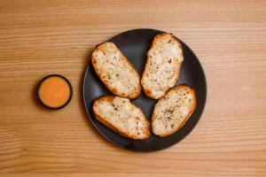 Garlic breads with dip served in dish isolated on table top view bangladeshi food photo