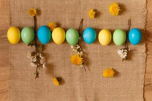 Paint eggs for Easter, bright Easter holiday, children paint eggs, colored eggs in a basket, colored eggs on a stand, Holiday background photo