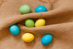 Paint eggs for Easter, bright Easter holiday, children paint eggs, colored eggs in a basket, colored eggs on a stand, Holiday background photo