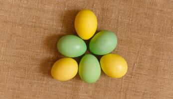 Paint eggs for Easter, bright Easter holiday, children paint eggs, colored eggs in a basket, colored eggs on a stand, Holiday background photo