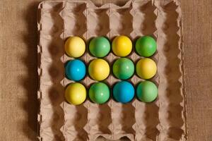 Paint eggs for Easter, bright Easter holiday, children paint eggs, colored eggs in a basket, colored eggs on a stand, Holiday background photo