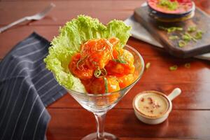 Dynamite egg with dip served in a goblet isolated on wooden background side view photo