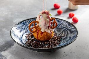 Fried Cheesecake with ice cream, chocolate chip and berries served in dish isolated on table top view of arabic breakfast photo