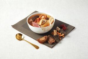 Morel Cordyceps Flower Abalone Stewed Chicken Soup served in a dish isolated on napkin side view of hong kong food photo