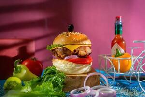 Chicken Cheese Burger with tomato, ketchup and green chilli isolated on wooden board side view of american fast food photo