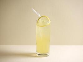 A glass of fresh iced honey lemon drink with straw isolated on grey background side view photo