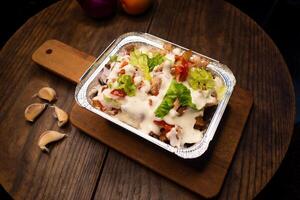 Pizza Loaded Fries topping with mayo and chilli sauce served in dish isolated on wooden board top view of italian fastfood spices snack photo