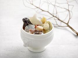 Mini Buddha Jump over the wall Served in a bowl isolated on wooden background side view on grey background photo