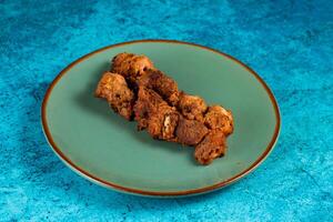 spicy bbq chicken tikka boti kabab served in a dish isolated on background top view photo