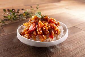 Iced Sweet and Sour Pork served dish isolated on wooden table top view of Hong Kong food photo