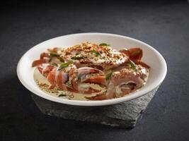 Signature Creamy Butter Sri Lankan Crab topped with Coconut Crumbs served in a dish side view on dark background photo