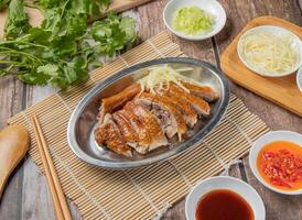 duck plate with chilli sauce, noodles, spoon and chopsticks served in dish isolated on napkin top view of hong kong food photo