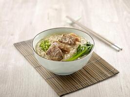 Stewed Beef Brisket Noodle with chopsticks served in a bowl isolated on mat side view on grey background photo