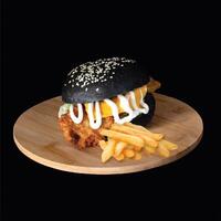 Fried Fish black Burger with french fries served on wooden board side view on black background fast food photo