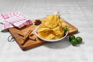 Fried wanton with lemon Chinese food top view on wooden cutting board photo