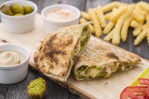 Falafel Pie wrap Meal with fries and dip served in dish isolated on table side view of arabic food photo