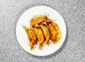 fried dumplings served in bowl isolated on background top view of hong kong food photo