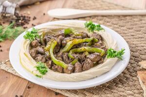 Liver Hummus served in dish isolated on table side view of arabic food photo