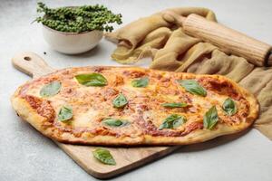 Margherita Pizza served in cutting board isolated on table top view of arabian food photo