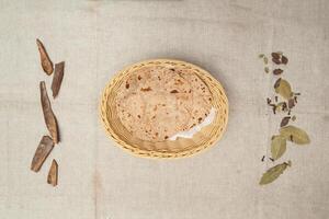 Plain Chapatti, roti, tandoori, bread served in a basket isolated on table top view of indian spices food photo