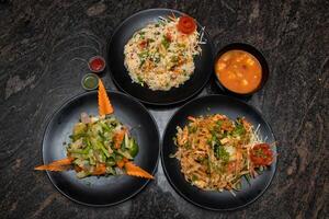 Chinese vegetable, Mixed fried rice, Pan Thai chow mein or chowmein and Thai soup served in dish isolated on background top view of bangladesh and indian food photo