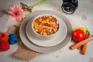 Creamy roma pasta with tomato in a plate top view on wooden background photo