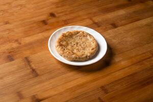 Chicken Patty served in plate isolated on wooden table top view of indian food photo