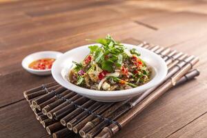 Spicy Wild Pepper Fresh Fish Skin served dish isolated on wooden table top view of Hong Kong food photo