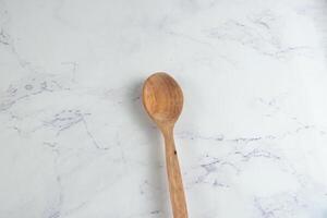 Wooden Spoon isolated on table top view photo