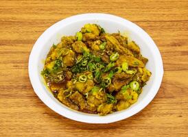 aloo gobhi served in plate isolated on table top view of indian and pakistani spicy food photo