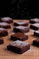 assorted brownie with chocolate and almond isolated on wooden table side view photo