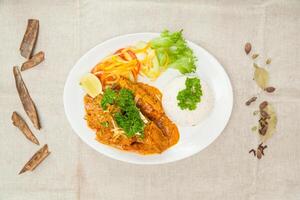 Mutton Rara gosth with plain rice, salad and lime served in a dish isolated on table top view of indian spices food photo