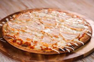 Turkey pizza served in cutting board isolated on background top view of fast food photo