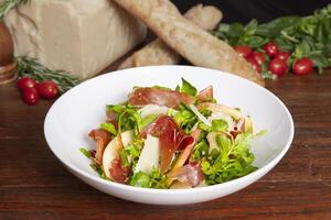 Serrano Ham Watercress Salad served in dish isolated on table top view of arabian food photo