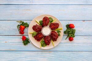 Valle Buffalo Mid Joint Wings with dip and tomato cherry Served in dish isolated on wooden table top view fastfood photo