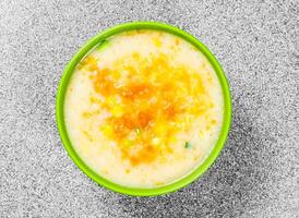 Pumpkin Polenta porridge served in bowl isolated on background top view of hong kong food photo