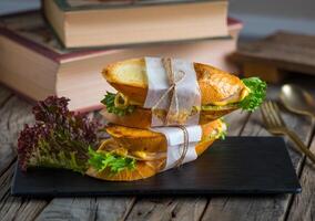 smoked turkish sandwich served in a dish isolated on cutting board side view of breakfast on wooden background photo