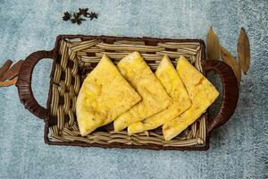 Kabli Naan or afghani nan served in a basket isolated on grey background top view of bangladesh food photo