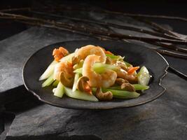 Sauteed Shrimp with Celery and Cashew Nut served in dish isolated on table top view of food photo