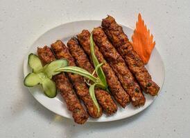 Spicy bbq chicken reshmi kabab served in a dish isolated on grey background top view of indian, pakistani food photo