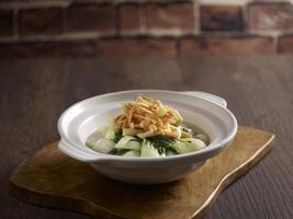 Braised Baby Cabbage in Superior Stock served in a dish isolated on mat side view on dark background photo