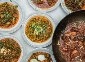 served in plate isolated on table top view of indian and pakistani spicy food photo