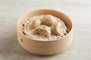 Steamed Prawn and Pork Dumpling served in a wooden bowl isolated on grey background photo