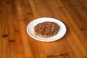 Beef Patty served in plate isolated on wooden table top view of indian food photo