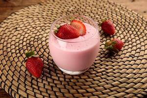 STRAWBERRY PANACOTTA served in a glass isolated on wooden background side view dessert photo