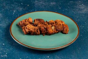 spicy bbq chicken tikka boti kabab served in a dish isolated on background top view photo