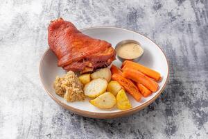 Crispy Pork Knuckle with dip, wedges and fries served in dish isolated on table top view of thai food photo