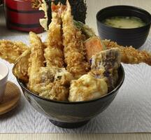 Tendon food tempura served in a dish isolated on wooden table side view of singapore food photo