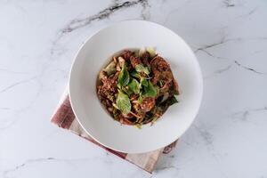 Pork Jar Salad with chicken and vegetables in a dish isolated on mat top view on grey marble background photo